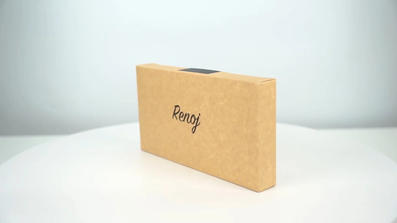 The plain kraft Renoj box on a packing table