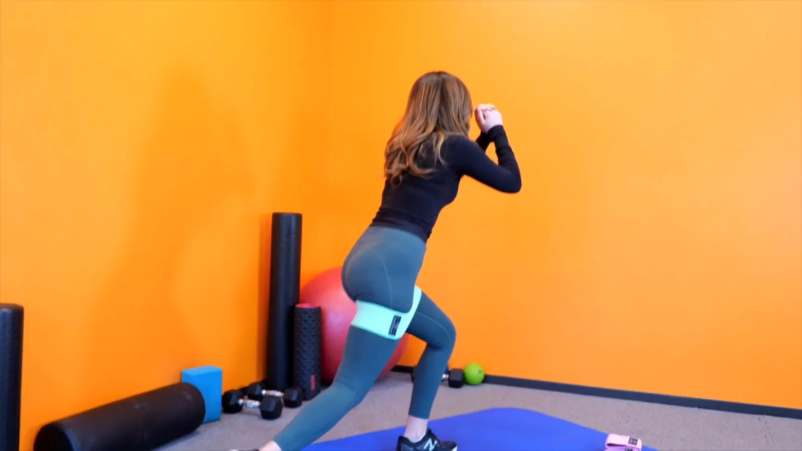 A Renoj hip band workout on a blue mat